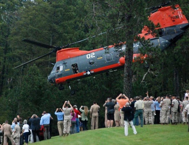 The last HH-46E Pedro lifts off from a grassy hill overlooking the Neuse River as a group of invitees watch from in front of Miller's Landing Club and Conference Center at Cherry Point Marine air station on Friday evening. The search and rescue function of Marine Transport Squadron One was ceremoniously ended Friday.