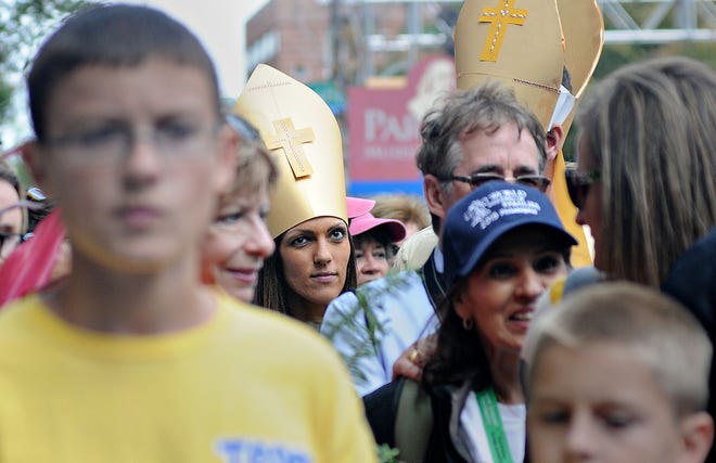 Dressed to see the Pope, Shireen Dastis makes her way through crowded sidewalks Saturday, September 26, 2015 in Philadelphia.