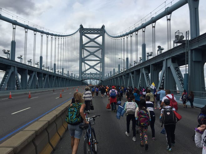 A lcrowd treks across the Benjamin Franklin Bridge from Camden to Philadelphia to see Pope Francis on Saturday, Sept. 26, 2015.