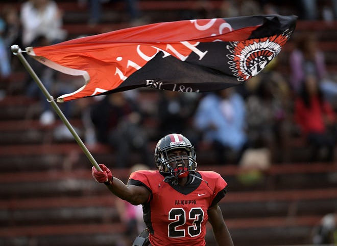 Aliquippa's Kaezon Pugh runs onto the field at the start of Friday night's game against Quaker Valley at Aliquippa.