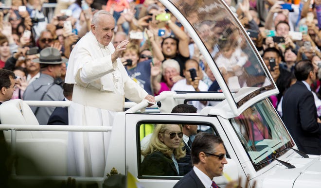 Pope Francis waves as he arrives for a speech on religious freedom Saturday at Independence Hall in Philadelphia.
