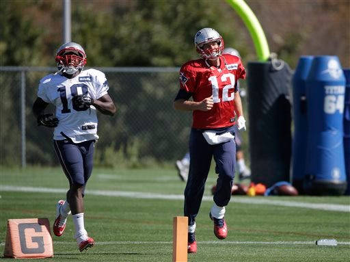 New England Patriots wide receiver Matthew Slater, left, and quarterback Tom Brady, right, run while warming up at NFL football practice, Wednesday, Sept. 23, 2015, in Foxborough, Mass. (AP Photo/Steven Senne)