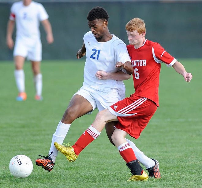 Adrian senior Davion Rodgers (21) and Clinton 
senior Luke Hayes battle for the ball Saturday in Adrian. The Maples won the non-conference game against Clinton 3-1. Telegram Photo by Bashar Alshabi