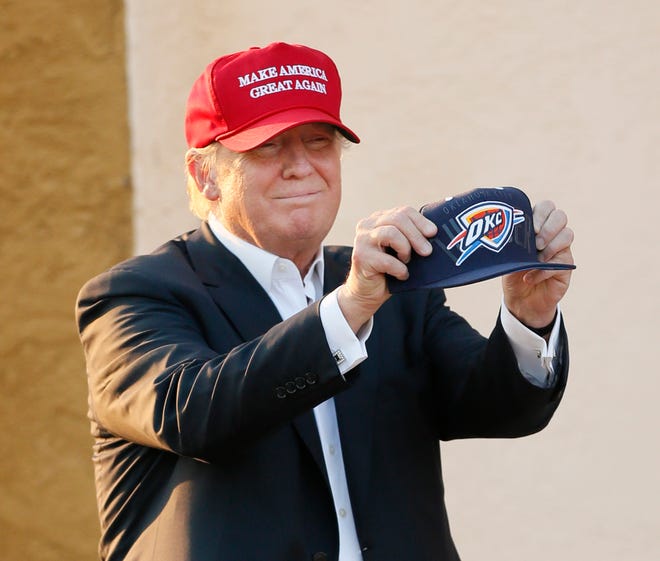 Donald Trump holds up an Oklahoma City Thunder hat at the Oklahoma State Fair in Oklahoma City before giving a speech during the 2016 presidential election Friday, Sept. 25, 2015. Photo by Nate Billings, The Oklahoman archives