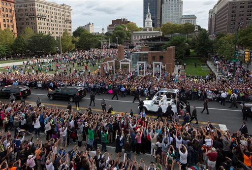Pope Francis passes the crowd in his pope mobile on Independence Mall in Philadelphia on Saturday, Sept. 26, 2015. The pope spoke at Independence Hall on his first visit to the United States. (AP Photo/Laurence Kesterson, Pool)