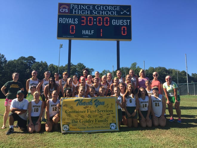 The Prince George Field Hockey team poses with a sign thanking Container First Services and the Guidry Family for the new scoreboard, pictured above. Contributed Photo.