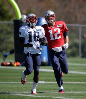 New England Patriots wide receiver Matthew Slater, left, and quarterback Tom Brady, warm up on the field during practice on Wednesday in Foxborough, Mass. (AP Photo/Steven Senne)