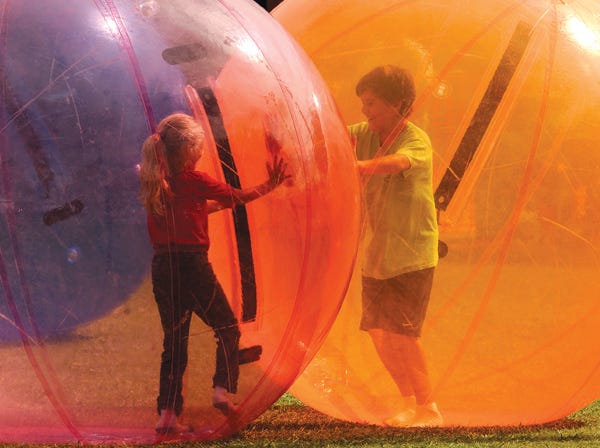 Marissa Carroll, 6, left, and her brother Braxten Carroll, 10, of Anniston, play in the human gerbil balls during Hokes Bluff City Fest on Saturday. The event continues Sunday with an evening of music starting at 4 p.m. Hokes Bluff native Drake White headlines the event at 7 p.m.