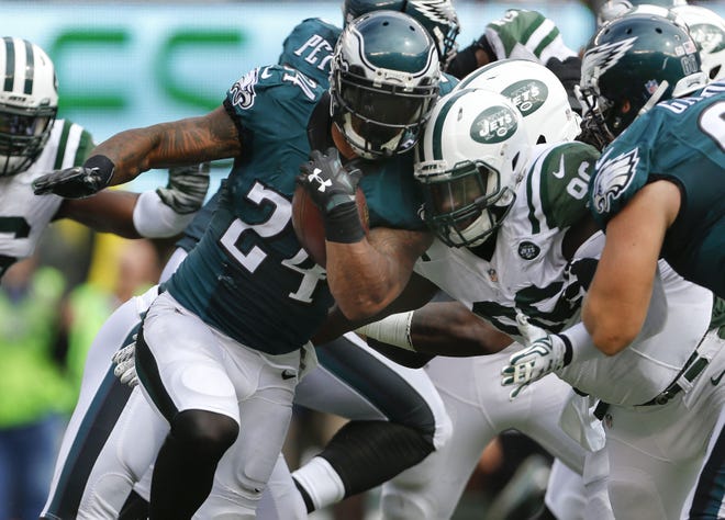 Eagles running back Ryan Mathews (24) is hit by Jets defensive end Muhammad Wilkerson (96) during Sunday's game.
