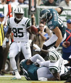Jets wide receiver Brandon Marshall (15) tries to lateral but it deflects off of Eagles outside linebacker Connor Barwin (98) as he is tackled by Eagles free safety Malcolm Jenkins (27) during the second quarter Sunday, Sept. 27, 2015, in East Rutherford, N.J. The Eagles recovered the ball on the play as the pass was ruled a fumble.