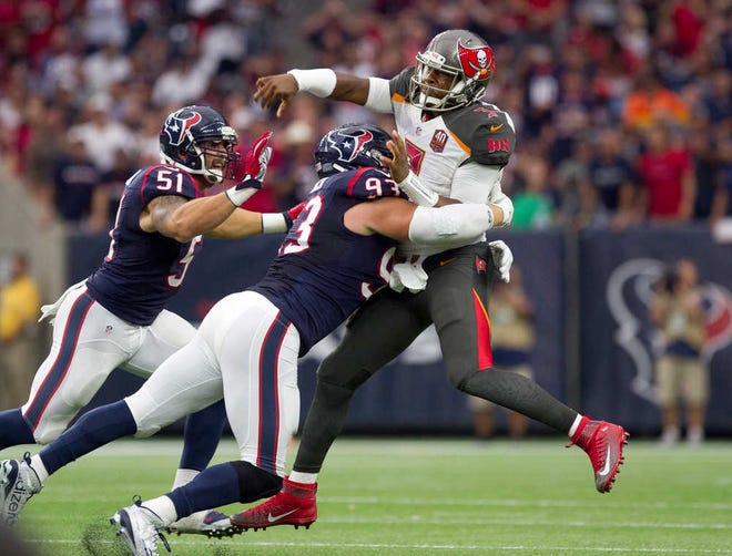 Tampa Bay Buccaneers quarterback Jameis Winston, right, is hit by Houston Texans defensive end Jared Crick after passing in the first half of an NFL football game Sunday, Sept. 27, 2015, in Houston. (Jason Fochtman/Conroe Courier via AP) MANDATORY CREDIT