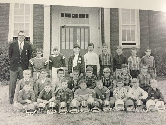 It was the fall of 1967 when this hearty group of Pop Warner football players were a team at Winecoff School outside Concord. Star Sports Editor Alan Ford, second from right on front row, writes about his coach, the late Bob Cook, standing at left.