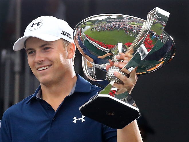 Jordan Spieth is presented the FedEx Cup after winning the Tour Championship golf tournament at East Lake Golf Club on Sunday, Sept. 27, 2015, in Atlanta.