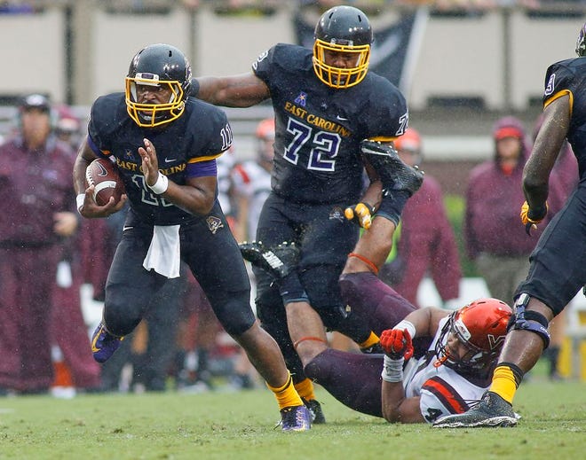 East Carolina quarterback James Summers runs away from the Virginia Tech defense Saturday.