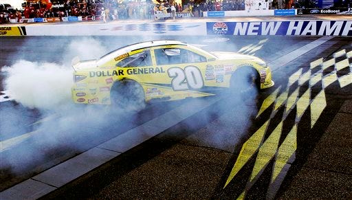 Matt Kenseth celebrates at the finish line after winning the NASCAR Sprint Cup series auto race at New Hampshire Motor Speedway. The Associated Press