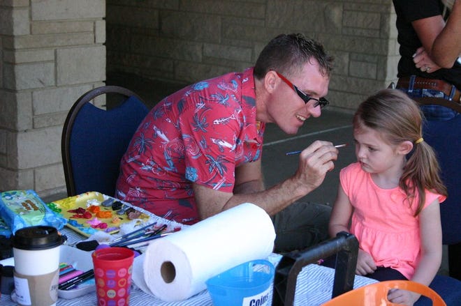 A young girl gets her face painted at the pavilion at Big Creek Park Saturday afternoon at Taste of Canton. Several area food establishments offered their best items for attendees to taste, and there were activities for the whole family.
