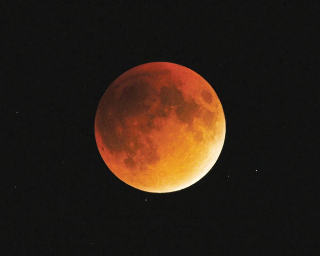 The moon is seen Sunday night from Tecumseh during the lunar eclipse, which coincided with a “supermoon,” which is when the moon makes its closest approach to Earth and appears slightly larger and brighter.