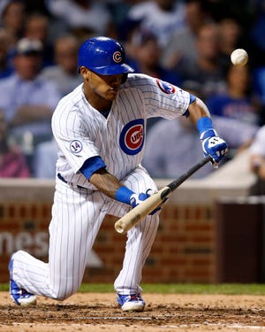 Chicago Cubs' Addison Russell connects for a bunt single against the Kansas City Royals during the sixth inning of a baseball game Monday, Sept. 28, 2015, in Chicago. (AP Photo/Andrew A. Nelles)
