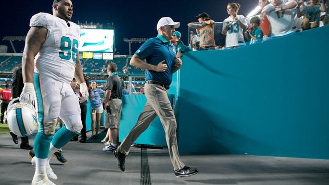 Miami Dolphins head coach Joe Philbin sprints off the field following loss to the Bills at Sun Life Stadium in Miami Gardens, Florida on September 27, 2015. (Allen Eyestone / The Palm Beach Post)