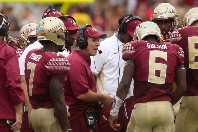 Florida State coach Jimbo Fisher, center, talks with his players, including quarterback Everett Golson, during a time out during a game against South Florida on Sept. 12 in Tallahassee. Florida State won the game 34-14. (AP Photo/Steve Cannon)