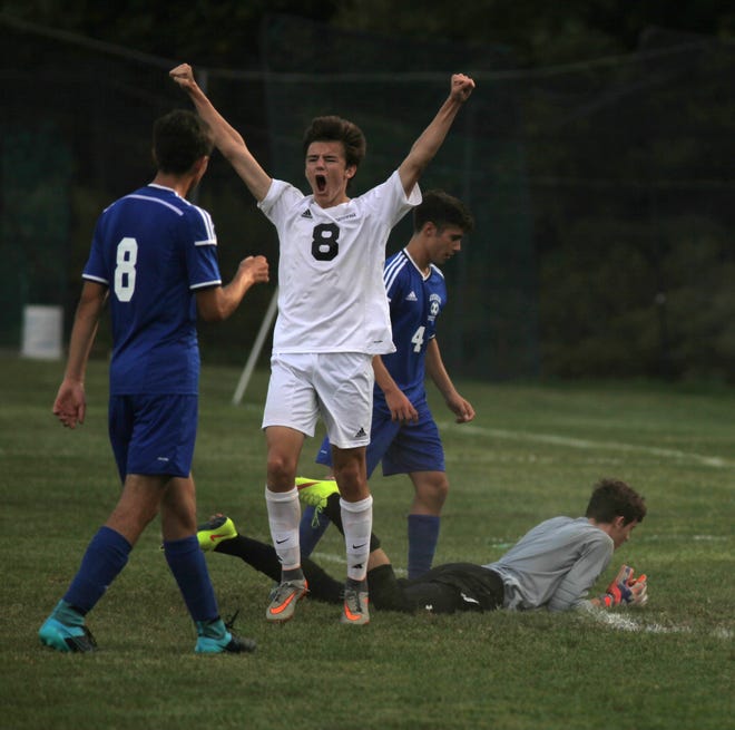 Cornwall sophomore forward Jake Burgess raises his arms in celebration after scoring a first-half goal against Goshen on Monday. WILL MONTGOMERY/TIMES HERALD-RECORD