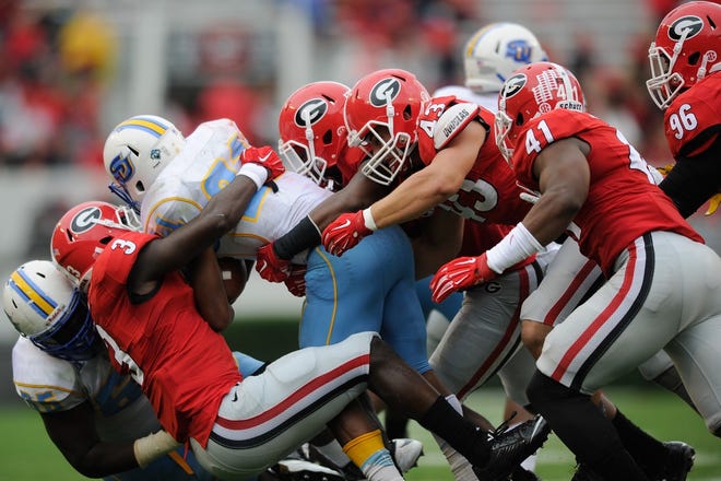 Georgia players tackle Southern University running back Lenard Tillery (21) during an NCAA college football game on Saturday, Sept. 26, 2015, in Athens, Ga.