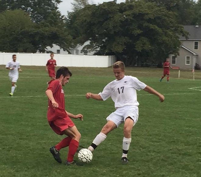 Burlington Township's Tyler Lipsack (right) and Matt Hannan of Rancocas Valley joust for a loose ball Tuesday in their Burlington County Scholastic League Liberty Division contest. Township handed the Red Devils their first loss of the year, 1-0.