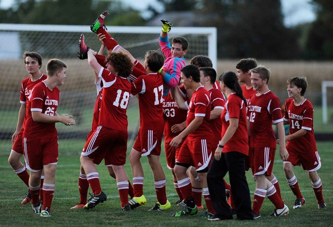 Clinton goalkeeper Jesse Fisher is hoisted up high by his teammates after blocking a shot during a 
penalty-kick shootout against Blissfield Monday. The Redskins won the 5-4 shootout to win the Independent Soccer League game after a 2-2 tie at the end of regulation. Telegram Photo by Bashar Alshabi
