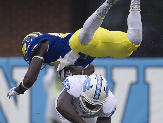 Delaware's Kareem Williams, top, is upended by North Carolina's Shakeel Rashad in the first quarter on Saturday, Sept. 26, 2015, at Kenan Stadium in Chapel Hill, N.C. The host Tar Heels won, 41-14. (Robert Willett/Raleigh News & Observer/TNS)