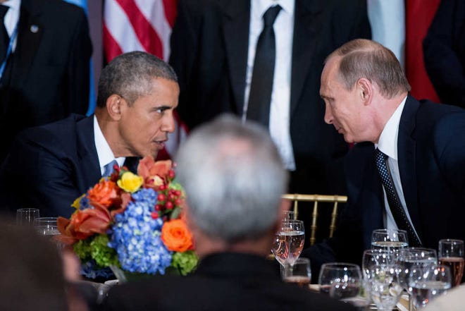 President Barack Obama and Russian President President Vladimir Putin greet each other during a luncheon, Monday, Sept. 28, 2015, at United Nations headquarters. (AP Photo/Andrew Harnik)