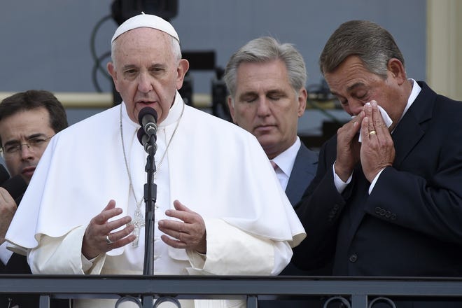 House Speaker John Boehner of Ohio (right) becomes emotional as Pope Francis appears on the Speaker's Balcony on Capitol Hill last Thursday and addresses the crowd below on the Capitol grounds. AP PHOTO