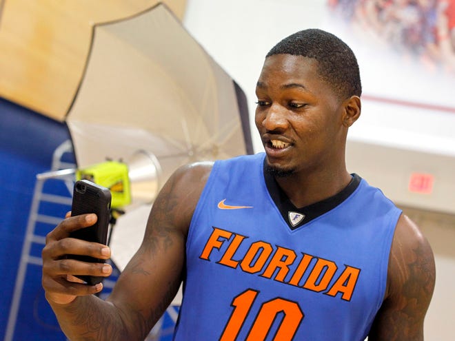 Dorian Finney-Smith takes a video during UF basketball media day Tuesday. Florida opens the season with an exhibition game against Palm Beach Atlantic on Nov. 5.