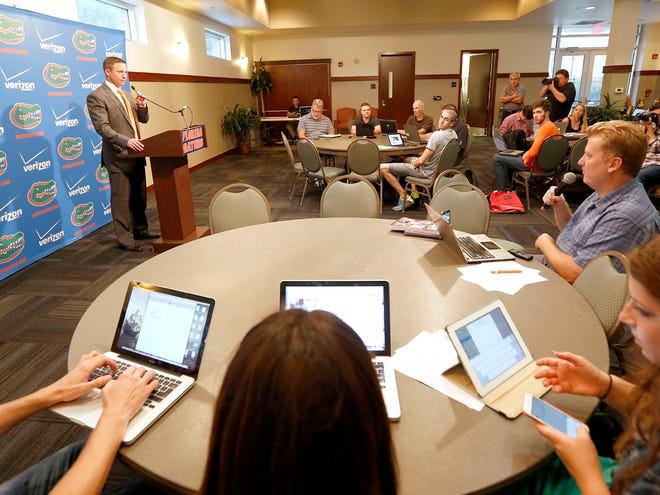 Members of the media listen as new Florida basketball coach Mike White speaks during basketball media day Tuesday.
