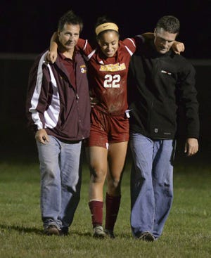 New Brighton's Maya Watkins is helped off the field after she suffered an injury Wednesday at South Side High School. New Brighton won, 6-5.