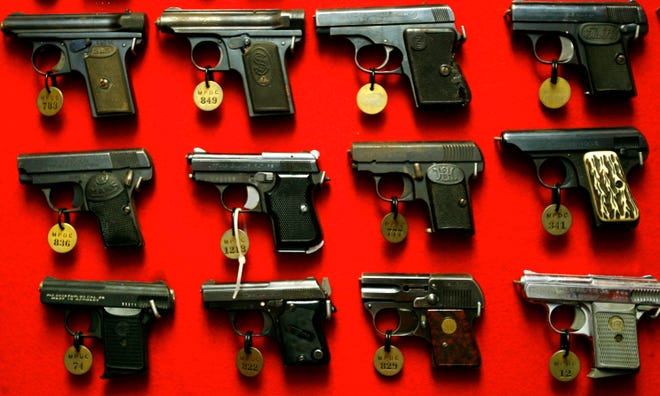 Guns line the walls in 2007 of the firearms reference collection at the Washington Metropolitan Police Department headquarters in Washington. A federal appeals court on Sept. 18 struck down as unconstitutional parts of a gun-control law in the nation’s capital that imposed strict registration requirements on handguns and long guns. The U.S. Court of Appeals for the District of Columbia Circuit ruled the city could not require gun owners to re-register a gun every three years, make a gun available for inspection or pass a test about firearms laws.