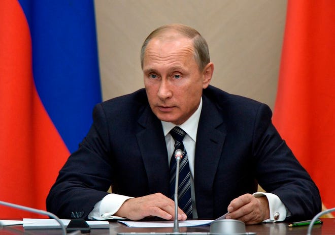 Russian President Vladimir Putin holds a meeting with senior government officials at the Novo-Ogaryovo residence outside Moscow, Russia on Wednesday, Sept. 30, 2015. Russian military jets carried out airstrikes against the Islamic State group in Syria on Wednesday for the first time, after President Vladimir Putin received parliamentary approval to send Russian troops to Syria. (Alexei Nikolsky/RIA Novosti, Kremlin Pool Photo via AP)