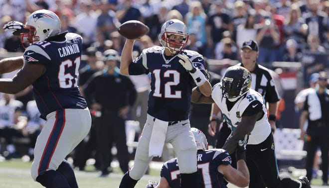 Patriots quarterback Tom Brady makes a throw during the first half of Sunday's 51-17 win over the Jaguars.