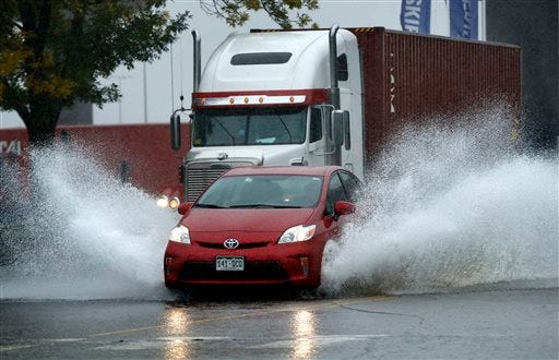 A motorist drives through flooding water in Portland, Maine, Wednesday, Sept. 30, 2015. Heavy rain has been moving through northern New England and a flood warning was issued for parts of Maine and New Hampshire.