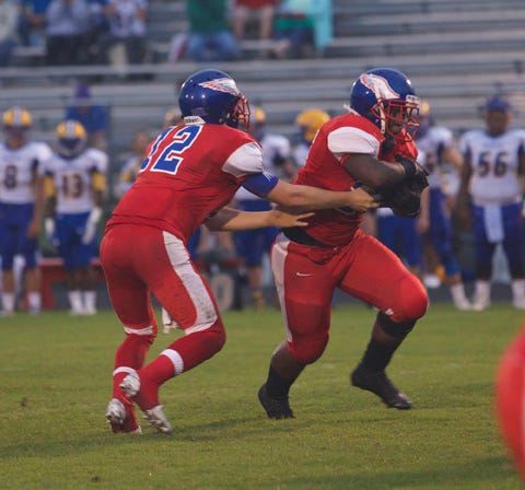 West Craven’s Jarred Arthur (12) hands off to Jaquel Whitehead during Monday’s game against Richlands. West Craven travels to Swansboro on Thursday.