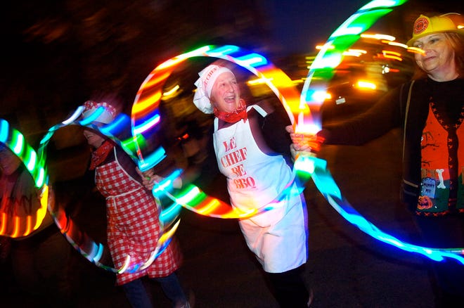 Heidi Delisle dances with glow-in-the-dark hula hoops in the Haunted Happenings opening parade. Wicked Local File Photo / Nicole Goodhue Boyd