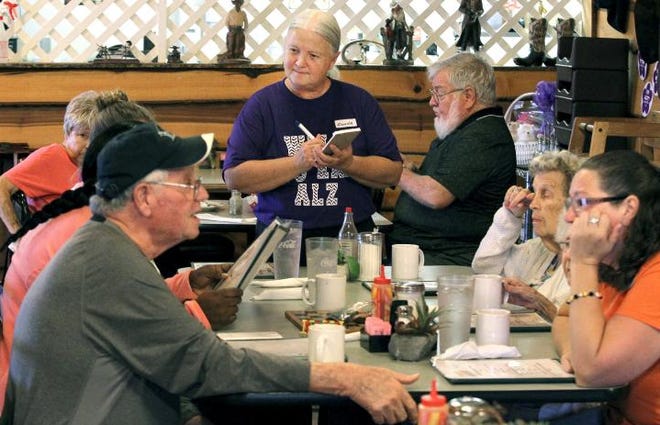 (John Clark/The Gazette) Friendly's of Stanley employee Donna Pope takes breakfast orders from the group from Stanley Total Living that were taking part in the first Alzheimer's Support Group that met at the restaurant Thursday morning.