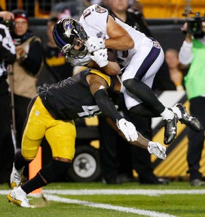 Baltimore Ravens wide receiver Michael Campanaro (15) scores a touchdown over Pittsburgh Steelers cornerback Antwon Blake (41) in the first quarter of an NFL football game, Thursday, Oct. 1, 2015 in Pittsburgh. (AP Photo/Gene J. Puskar)