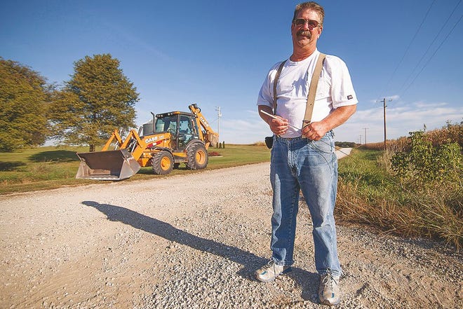 In Knox County, Henderson Township Highway Commissioner Bill Stone stands at the corner of Knox Roads 300E and 2350N as he works on Sept. 23. Township road districts maintain 53 percent of the roads in Illinois.