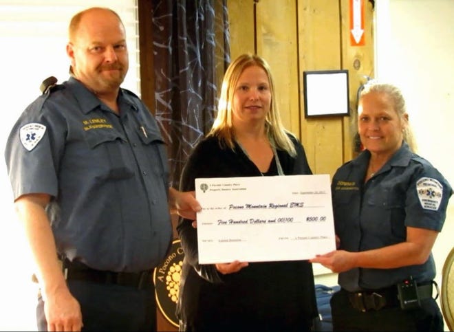 A Pocono Country Place POA presents a $500 donation to Pocono Mountain Regional Emergency Services. From left are Mark Lemley, BLS Coordinator; Cathleen LaBosco, Community Manager of A Pocono Country Place; and Denise Doremus, PMRES Operations Manager. (Photo provided)