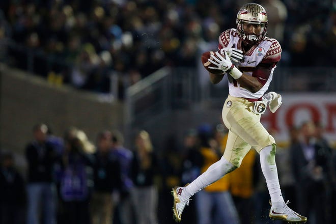 Florida State wide receiver Travis Rudolph (15) can't make a catch, that deflected off his shoulder and was intercepted by Oregon safety Erick Dargan (4) in the Rose Bowl NCAA college football playoff semifinal, Thursday, Jan. 1, 2015 in Pasadena, Calif. Oregon defeated Florida State 59-20 to advance to the first ever NCAA football playoff championship game.