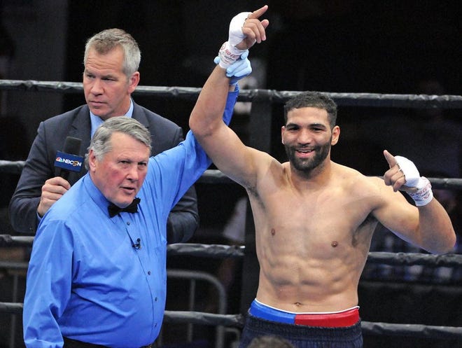 Referee Bill Benoit raises the arm of Light Heavyweight Edwin Rodriguez, after his third round TKO of Craig Baker, at the Agganis Arena in Boston, Saturday, May 23, 2015. T&G StAFF/STEVE LANAVA