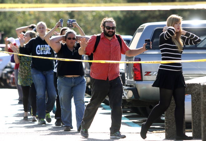 Students, staff and faculty are evacuated from Umpqua Community College in Roseburg, Oregon, after a deadly shooting Thursday. Photo/The News-Review via AP