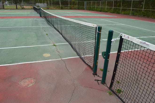Cracks and patches cover the surface of the Belmonte Middle School tennis courts. Photo/ Jeannette Hinkle