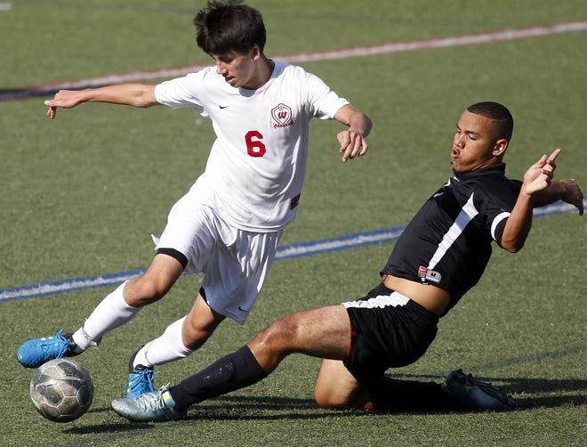 Marlborough's Paulo Silva (right) attempts to make a sliding tackle on Westborough's Greg Amador during last week's game. The Rangers prevailed, 2-1. Wicked Local Staff Photo/Marshall Wolff