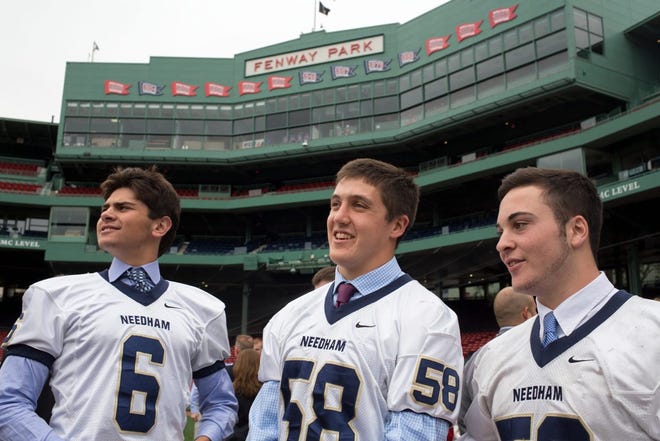 Needham senior captains Sam Foley, Joe Gowetski, and Ryan McCarthy check out the field at Fenway Park in Boston on Oct. 1, 2015. Hosted by Fenway Sports Management, top area Thanksgiving rivalries in high school football will return to Fenway Park for the first time since 1935.  (Wicked Local Photo/Zack DeClerck)